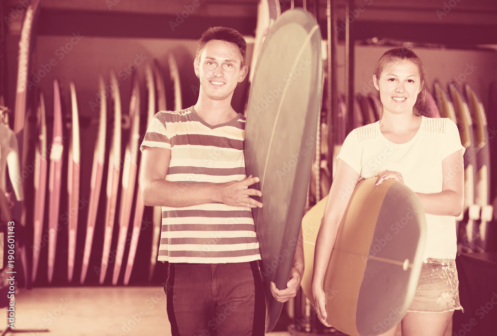 Couple is ready for surfing with board in time summer holidays