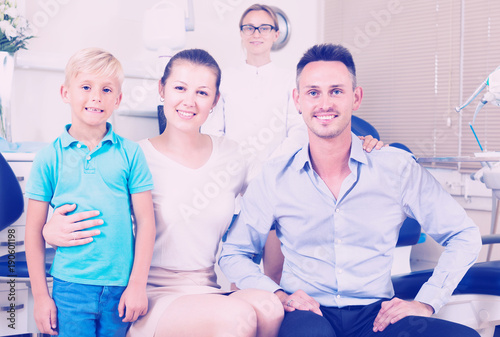 Young family of three is on dentist's receptionist