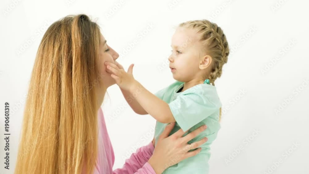 Happy young mother and daughter playing, drawing, playing games on your smartphone braid braids, read. Happy young mother and daughter playing, drawing, playing games on your smartphone braid braids, read.