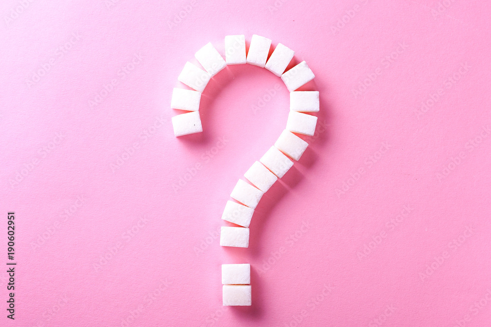 Question mark from white sugar cubes on a pink background Question mark from white sugar cubes on a pink background