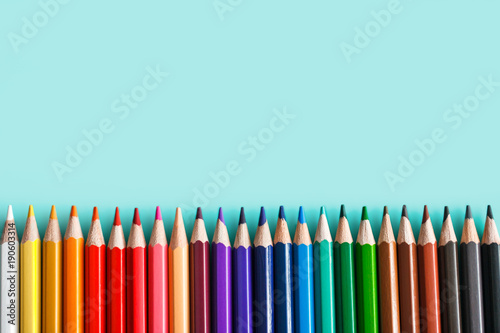 set of colorful pencils on pastel background