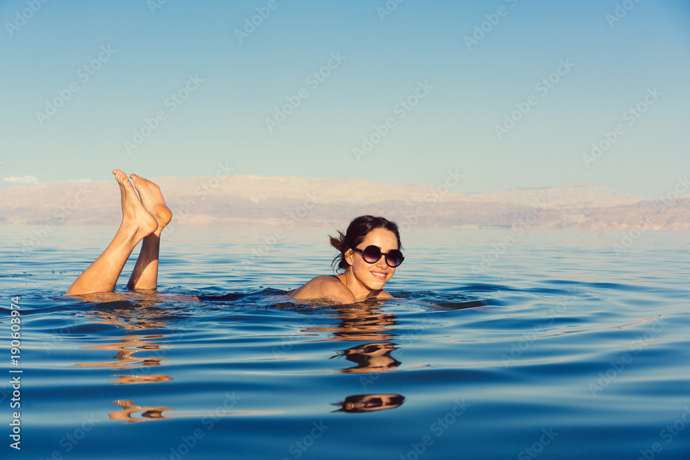 Girl is relaxing and swimming in the water