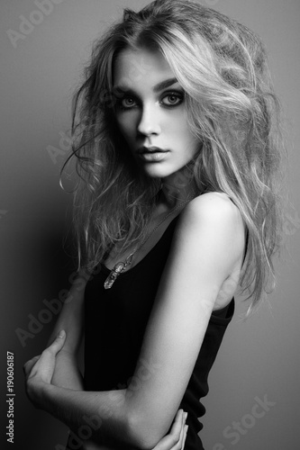 Portrait of young beautiful girl with blonde hair. Fashion photo. Hairstyle. Make up. Vogue Style. Black and white photo