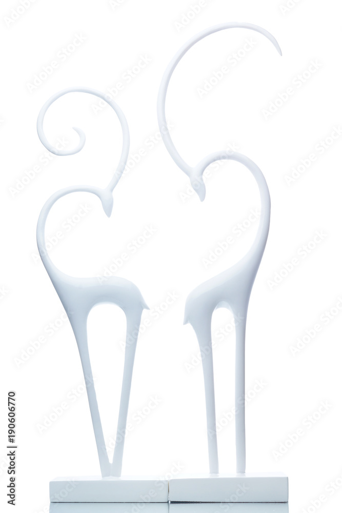Two white figures of graceful gazelles on a white background, turned towards each other, a symbol of love and fidelity Two white figures of graceful gazelles on a white background, turned towards each other, a symbol of love and fidelity