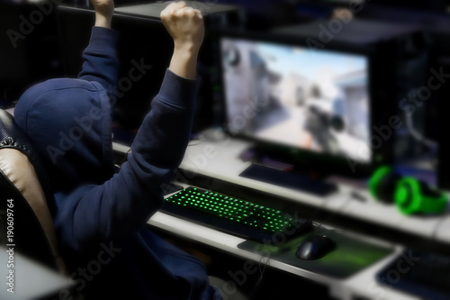 Gamer win the computer games until morning at internet cafe, game addiction concept, gamer lifestyle.