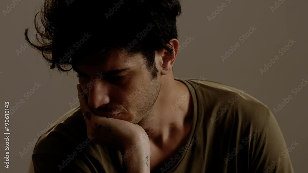 Pensive and sad youn man alone looking up Pensive and sad youn man alone looking up