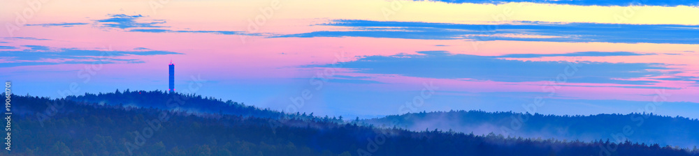 Dusk over hilly forest. Europe, Poland, Holy Cross Mountains.