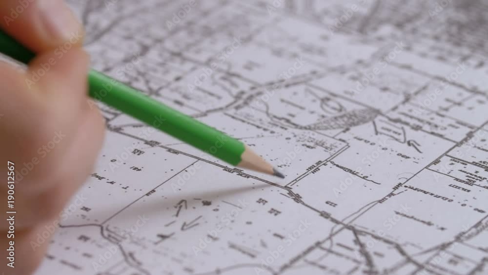 Engineer writing on Hydrological map with a pencil