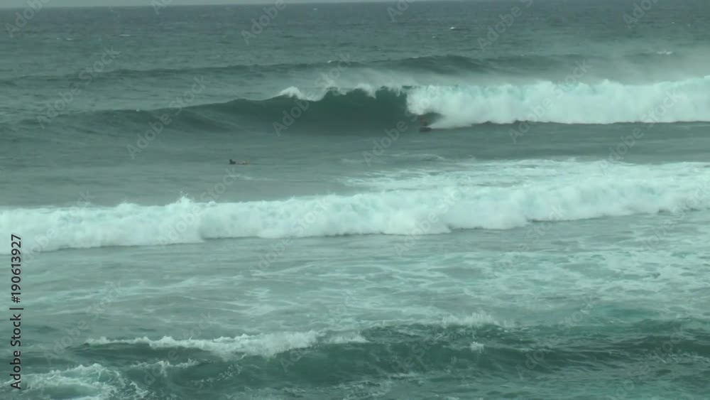 Surfers on the huge Pacific waves off the coast of the Hawaiian island of Maui Surfers on the huge Pacific waves off the coast of the Hawaiian island of Maui