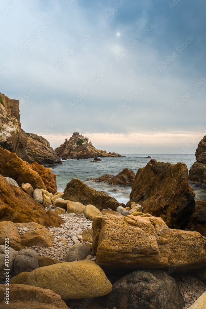 Sunset on a single beach full of rocks. Sunset on a single beach full of rocks.