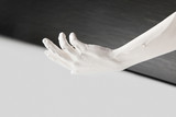 cropped image of female hand in white paint above black and white surface