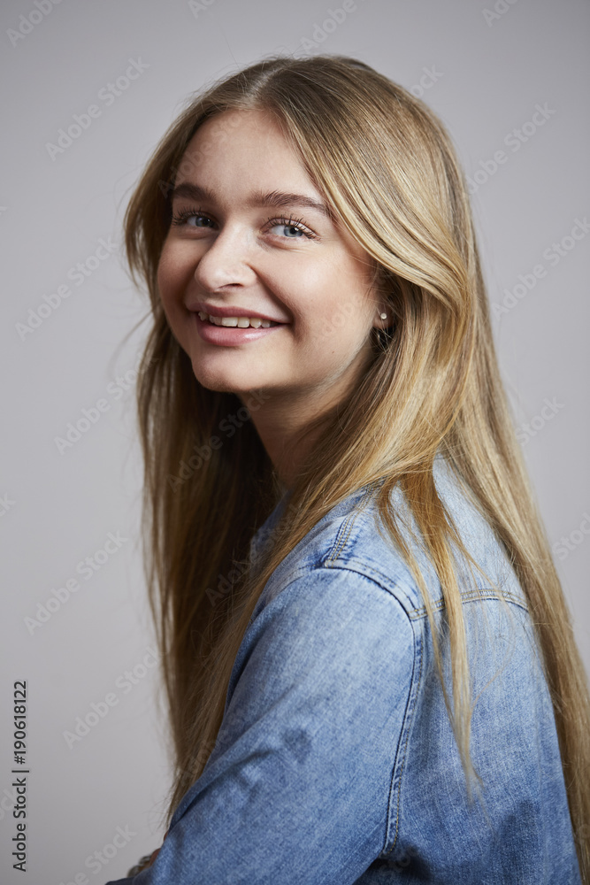 Smiling girl in denim shirt, portrait