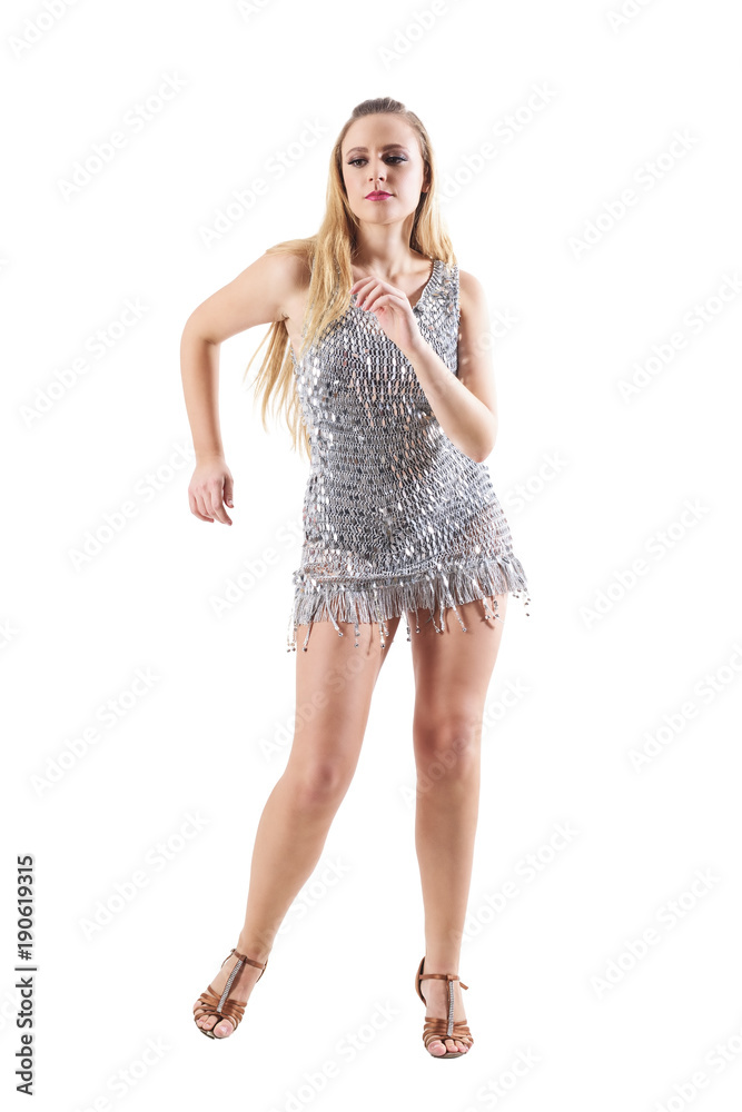 Blonde party woman dancing in scale sequin metallic dress. Full body length portrait isolated on white studio background. Blonde party woman dancing in scale sequin metallic dress. Full body length portrait isolated on white studio background.