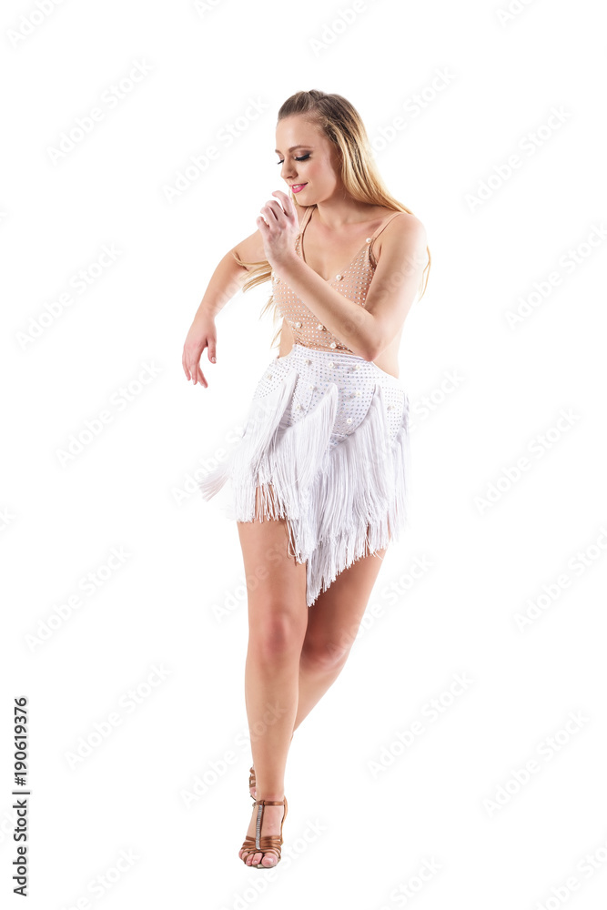 Happy smiling woman dancing latino dances and looking down. Full body length portrait isolated on white studio background. Happy smiling woman dancing latino dances and looking down. Full body length portrait isolated on white studio background.