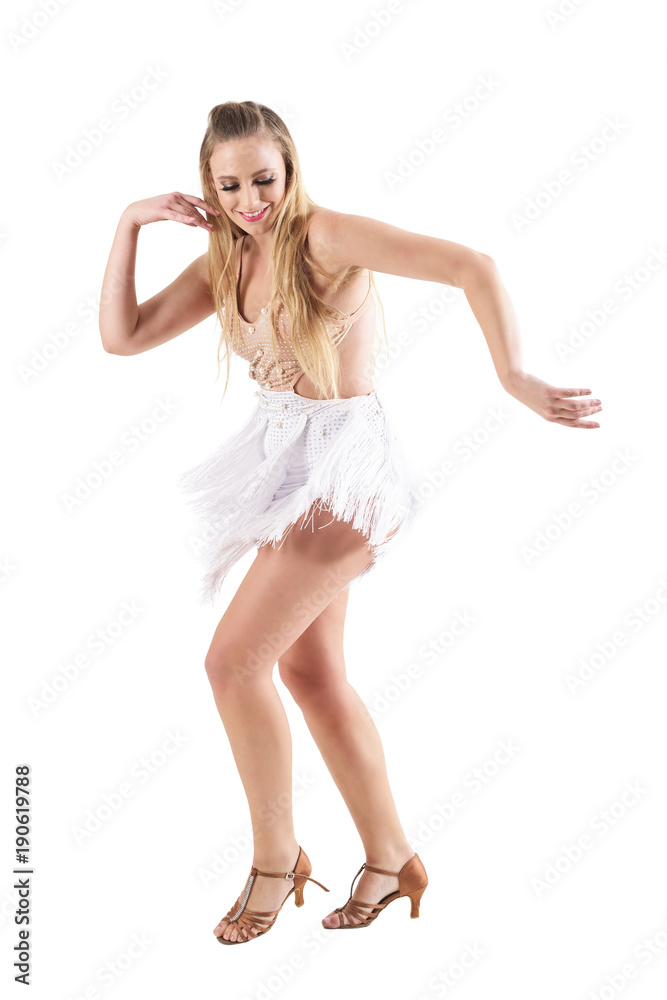 Carefree attractive blonde woman dancing latino dances smiling and looking down. Full body length portrait isolated on white studio background. Carefree attractive blonde woman dancing latino dances smiling and looking down. Full body length portrait isolated on white studio background.