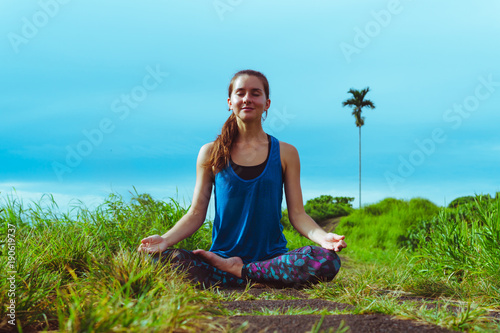 Woman meditates in yoga asana Padmasana