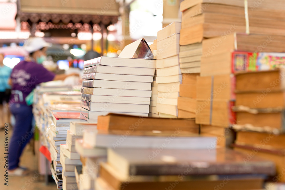 Fototapeta premium Piles of old books on a table