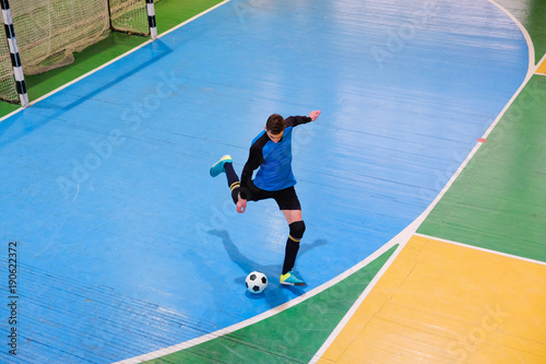 Football goalkeeper on goal, field, Futsal ball field in the gym indoor, Soccer sport field photo