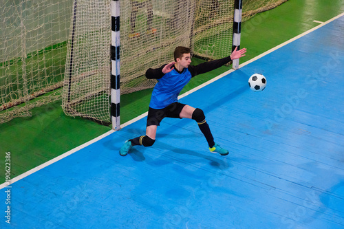 фотографія Football goalkeeper on goal, field, Futsal ball field in the gym indoor, Soccer