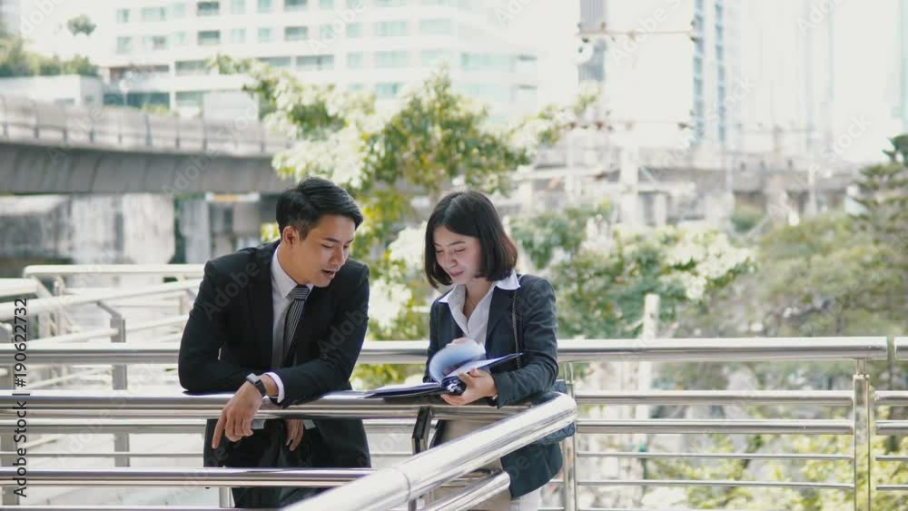 Two employees are viewing document on the bridge Two employees are viewing document on the bridge