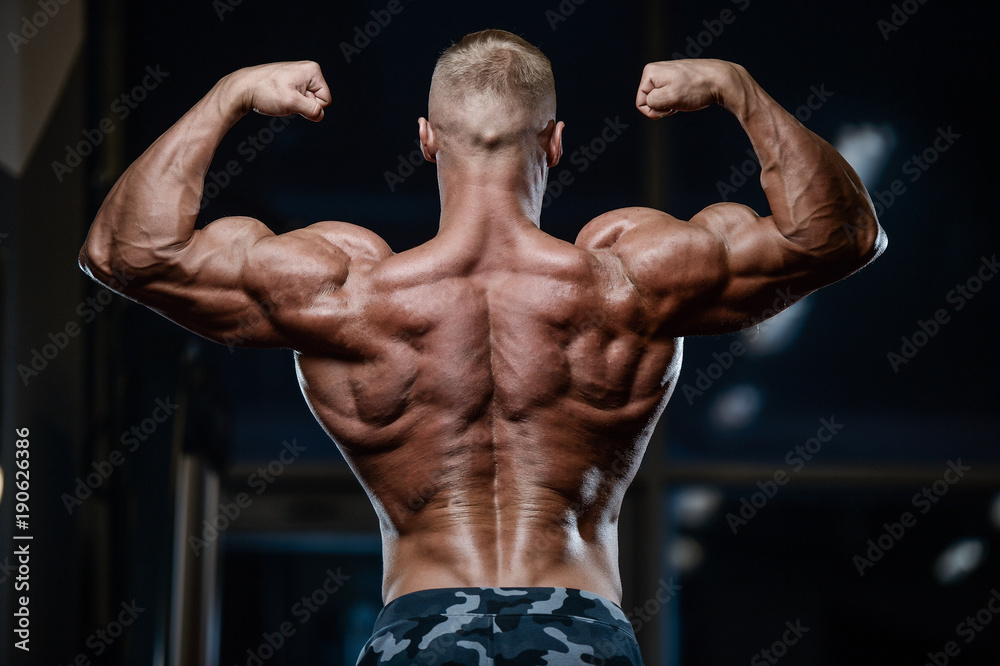 Brutal strong bodybuilder athletic men pumping up muscles with dumbbells. Brutal strong bodybuilder athletic men pumping up muscles with dumbbells.