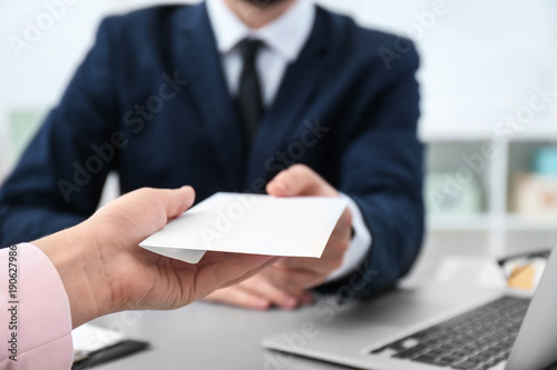Fotografija Businessman taking envelope with bribe from woman indoors, closeup