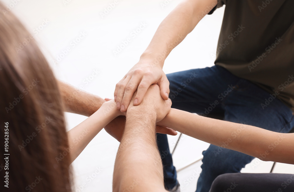 Obraz premium People putting hands together, closeup. Unity concept