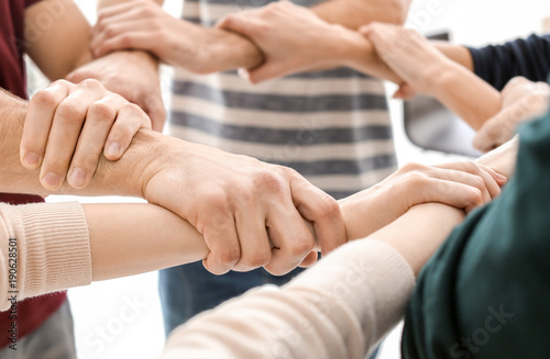 People holding hands together, closeup. Unity concept