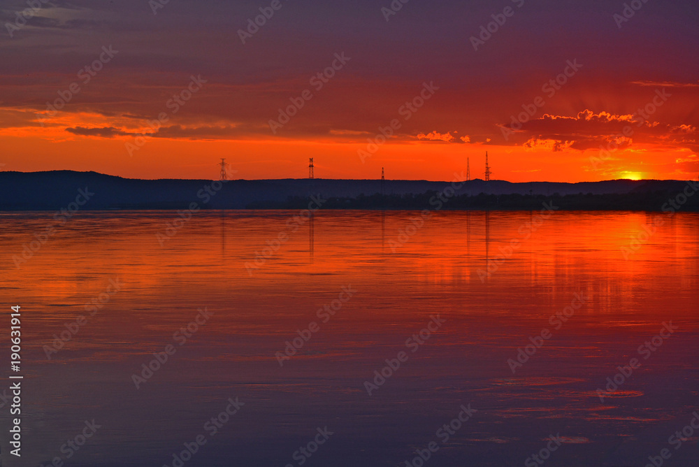 Sunset over the river. The reflection of the setting sun in the water. Sunset over the river. The reflection of the setting sun in the water.