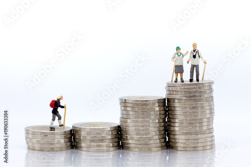 Miniature people: Old people standing on top of stack coins . Image use for background retirement planning, Life insurance concept.