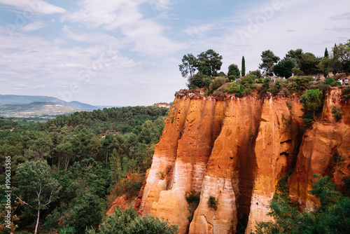 Ochre trail in Provence, south France.Vidid orange rock formation, summer time