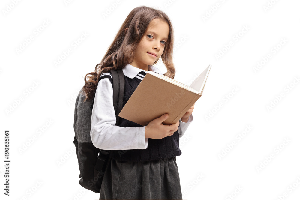 Schoolgirl holding a book and looking at the camera Schoolgirl holding a book and looking at the camera