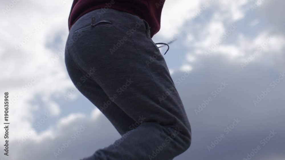 Young athletic man skipping with a jump rope outdoors in the city, in slow motion Young athletic man skipping with a jump rope outdoors in the city, in slow motion