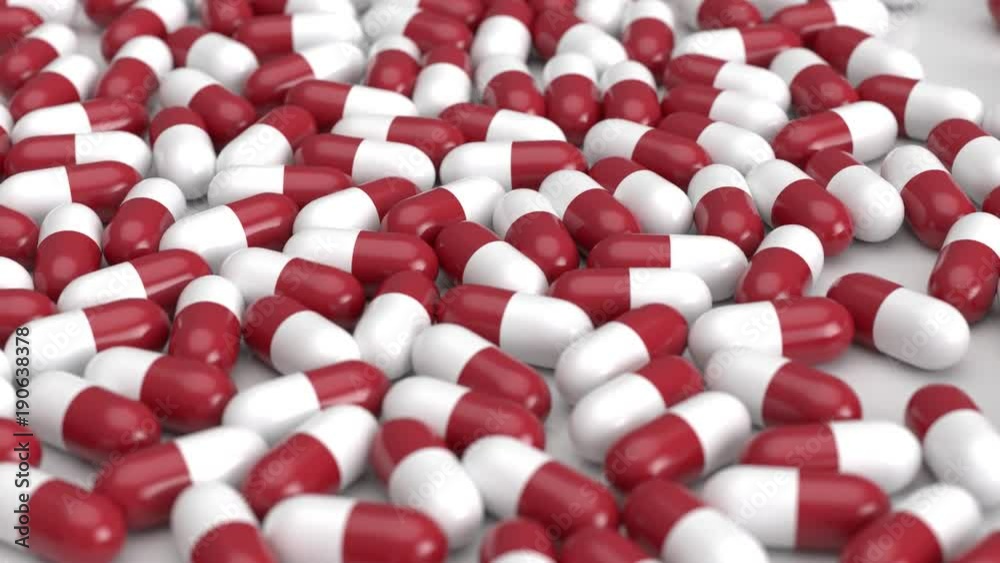 Rot weiße Tabletten - Pillen fallen auf den Boden Rot weiße Tabletten - Pillen fallen auf den Boden