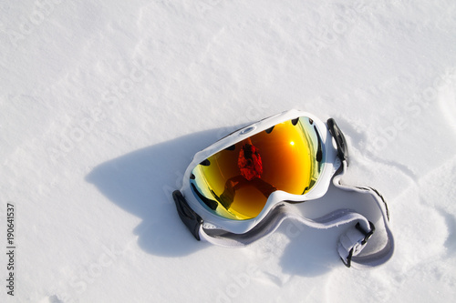the photographer's reflection in snowboarder glasses