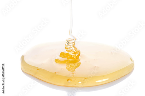 pouring honey on white background