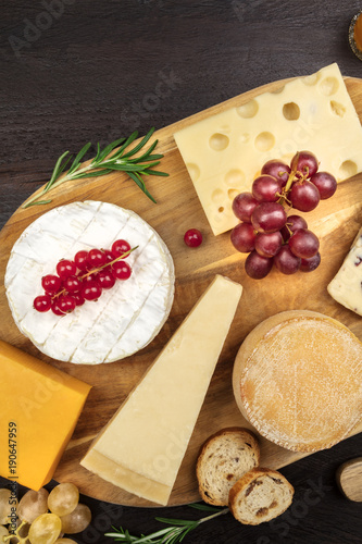 Various types of cheese on rustic background with copyspace