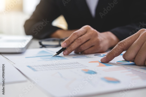 Business team two executive colleagues discussing and analysis working Financial investment on calculator with calculate on tablet Analyze business and market growth on financial document data graph