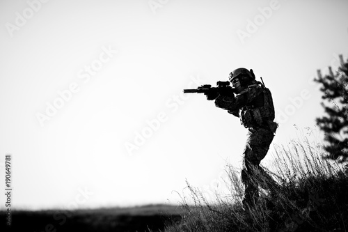 military soldier with weapons at sunset. shot, holding gun, colorful sky. military concept.