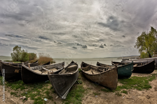 Beautiful morning landscape with a cloudy sky and fishing boats at the Razelm Lake shore  Sarichioi  Romania