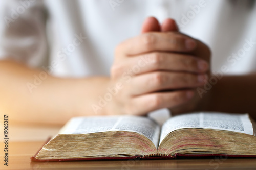 Woman reading holy bible.