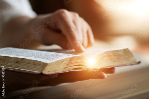 Woman reading holy bible.