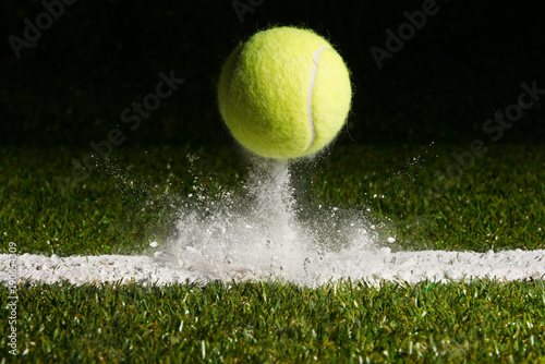 Match point with a tennis ball hitting the line