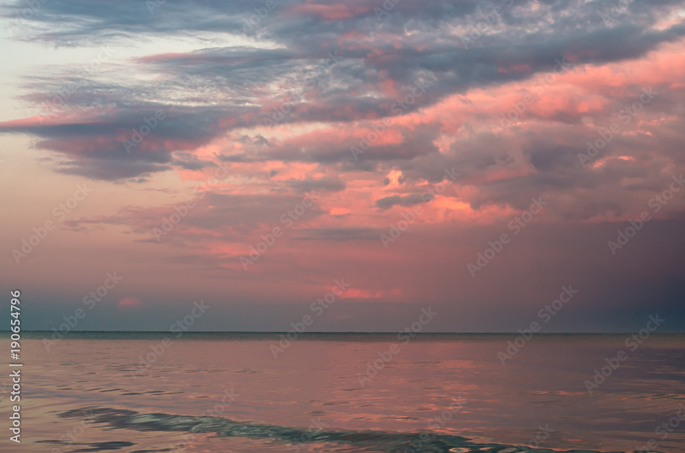 storm clouds on the Azov Sea, illuminated by the setting sun, the sea horizon.