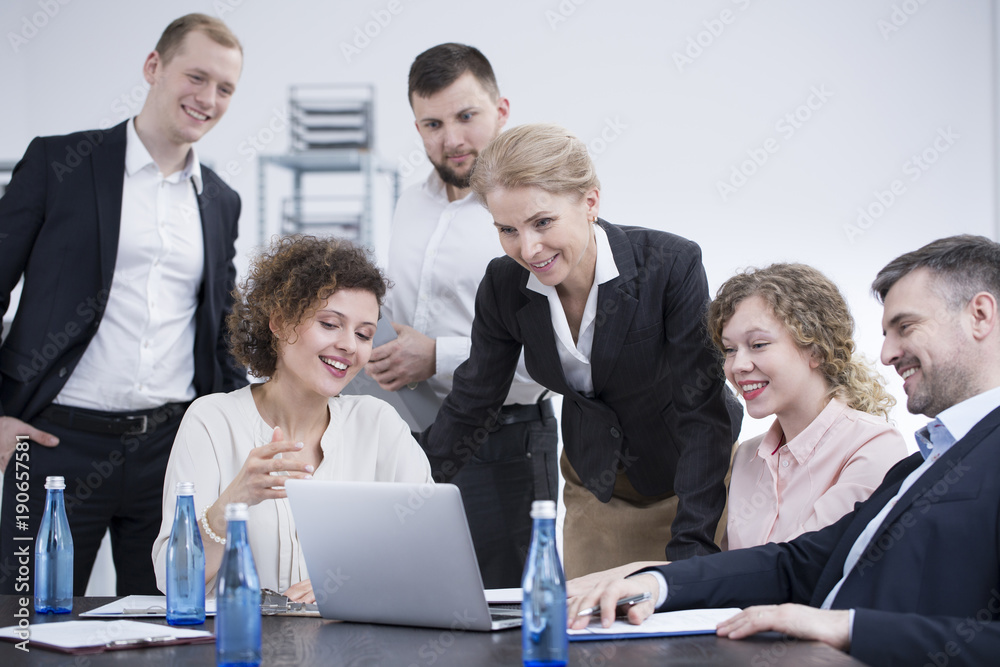 Smiling employees brainstorming