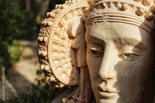 Lady of Elche bust in a garden under the sun photo