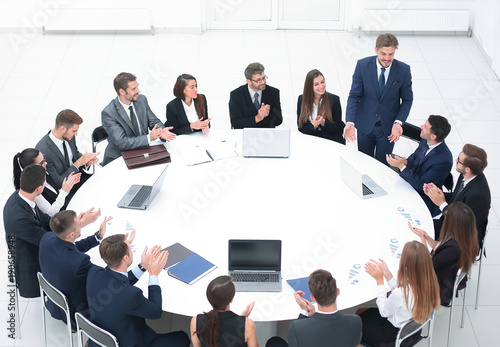 business people applauding speaker at a business meeting.
