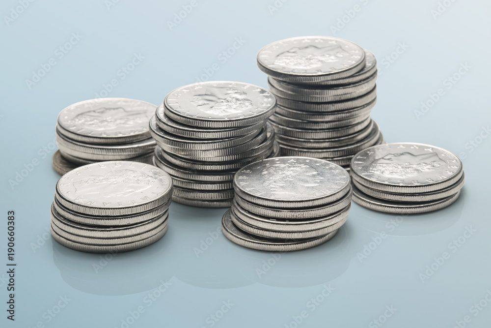 stacks of coins isolated on a reflective surface stacks of coins isolated on a reflective surface