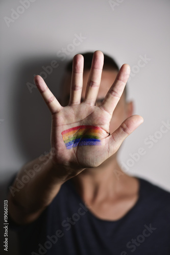 man with a rainbow flag in his hand