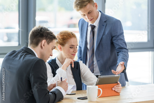 Young business team working on tablet in modern office